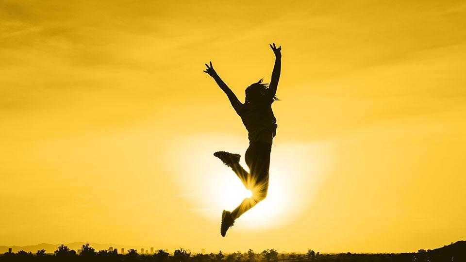 silhouette of student jumping in the air